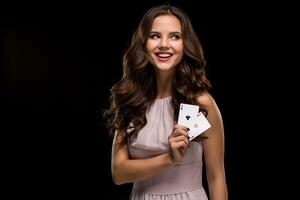 Attractive young woman holding the winning combination of poker cards photo