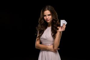 Attractive young woman holding the winning combination of poker cards photo