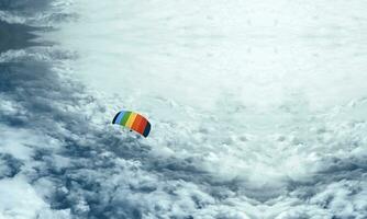 Aerial view of a skydiver from the sky, picture of a skydiver from the clouds with copy space photo