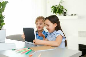 Learning from home, Home school kid concept. Little children study online learning from home with laptop. Quarantine and Social distancing concept. photo