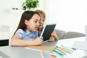 Learning from home, Home school kid concept. Little children study online learning from home with laptop. Quarantine and Social distancing concept. photo