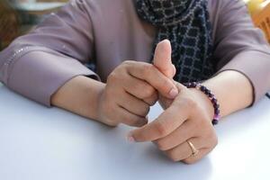 Young women hands suffering thumb finger pain photo
