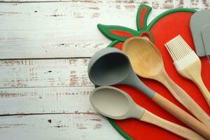 wooden cutlery forks and a chopping board on wooden background photo