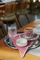 turkish coffee served with glass of water and delight photo