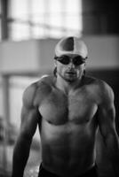 a man in a swimming pool wearing goggles photo