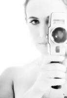 a woman holding a camera in front of her face photo