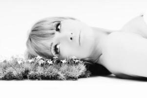 a black and white photo of a woman with flowers