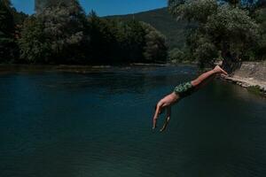 a man in a swimsuit is jumping into the water photo