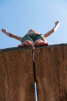 a boy is standing on a wooden platform photo