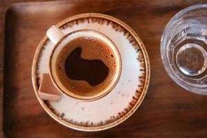 a cup of turkish coffee on table photo