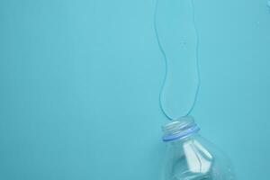 a bottle of water spilled on a table , photo