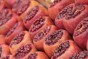 Bunch of Pomegranates on the greengrocer market. photo