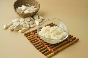 close up of minced garlic on a wooden spoon photo