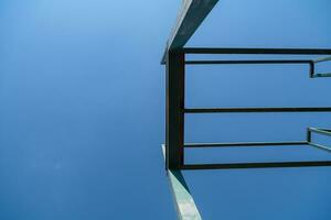 a view of a metal bench against a blue sky photo