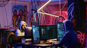 Hackers rushing to change their location after doing financial theft in dark bunker. Cybercriminals hiding their identity, removing any traces after stealing users bank account credentials video