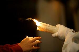 a child asking for wax during holy week photo