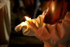 A Nazarene hand with a candle in Holy Week photo