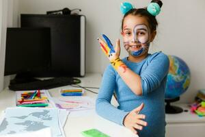 pequeño niña estudiando teatro en ordenador portátil en línea foto