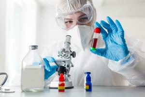 Young Female Scientist Analyzing Sample In Laboratory photo