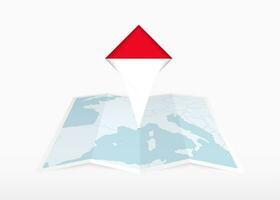 Monaco is depicted on a folded paper map and pinned location marker with flag of Monaco. vector