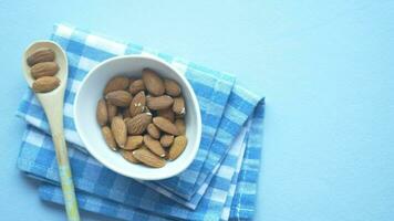 top view of almond nuts in a bowl on table video