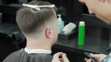 Professional barber giving a haircut to a male customer video