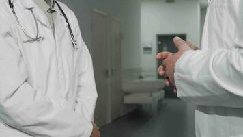 Unrecognizable doctors shaking hands at the hospital video