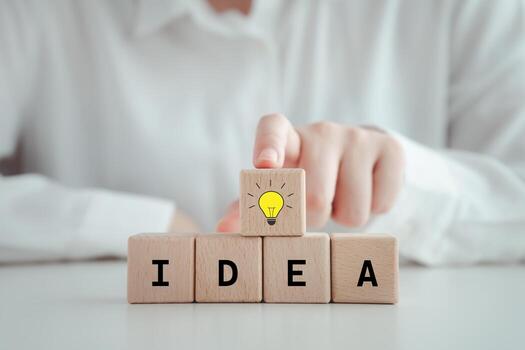 Idea and creativity concept. Creative process concept and problem solution. Hand touch on glowing light bulb for solving problem or set strategy and target. photo