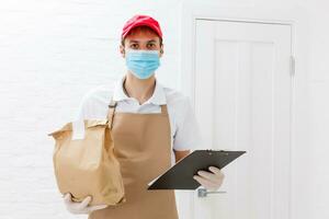 Diverse of paper containers for takeaway food. Delivery man is carrying photo