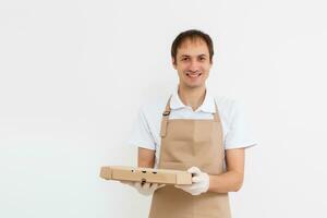 Photo of happy man from delivery service in t-shirt giving food order and holding pizza boxes isolated over white background