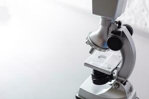 microscope stands on a table on a white background photo