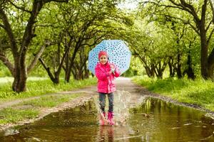 little girl riding bike in water puddle photo