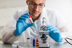 Young scientist looking through a microscope for Covid-19 Virus in a laboratory. Protective Epidemic Corona Virus, Covid-19 outbreak concept photo