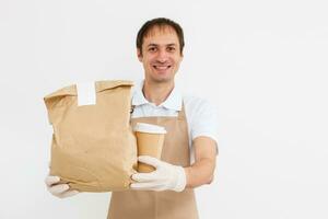 delivery man working in shirt with apron and protective gloves hand holding parcel isolated white background photo