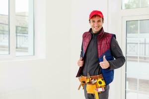 Portrait of happy repairman worker with tools photo