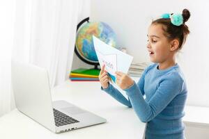 little girl studying art studio on laptop online, distance learning photo