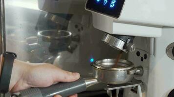 Cropped shot of a barista grinding coffee in coffee machine video