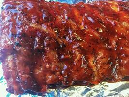 Honey Baked Pork Ribs on the aluminum foil. photo