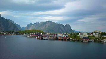 Aerial view of picturesque fishing town of Reine on Lofoten islands in Norway, popular tourist destination on sunny summer day. 4k video