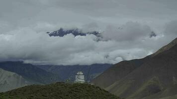 Time lapse of clouds in the mountain. Trek around Annapurna, Buddhist stupa on the hill. Nepal, Himalayas. 4K video