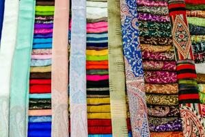 colorful scarves for sale at a market photo