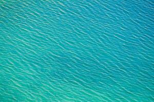 the ocean is blue and clear with ripples photo