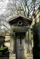 a small tomb with a cross on top of it photo