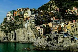 houses on the side of a cliff overlooking the ocean photo