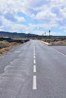 an empty road with a white line on it photo