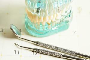 Dental appointment reminder in calendar, healthy teeth, dental health care. photo