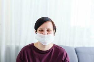 Girl with mask to protect her from Corona virus. Corona virus pandemic. woman wearing a face mask, looking at camera photo