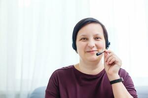 Headshot portrait of smiling young woman. girl with happy facial expression looking at camera with joy, communicating with friends via internet telephony, making video call. Close up. Front view photo