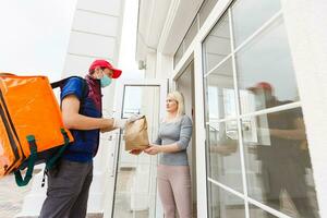 delivery man with thermo backpack and businesswoman in office photo