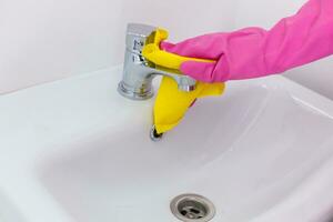 Cleaning Service Worker, hand in protective rubber gloves holding microfiber photo
